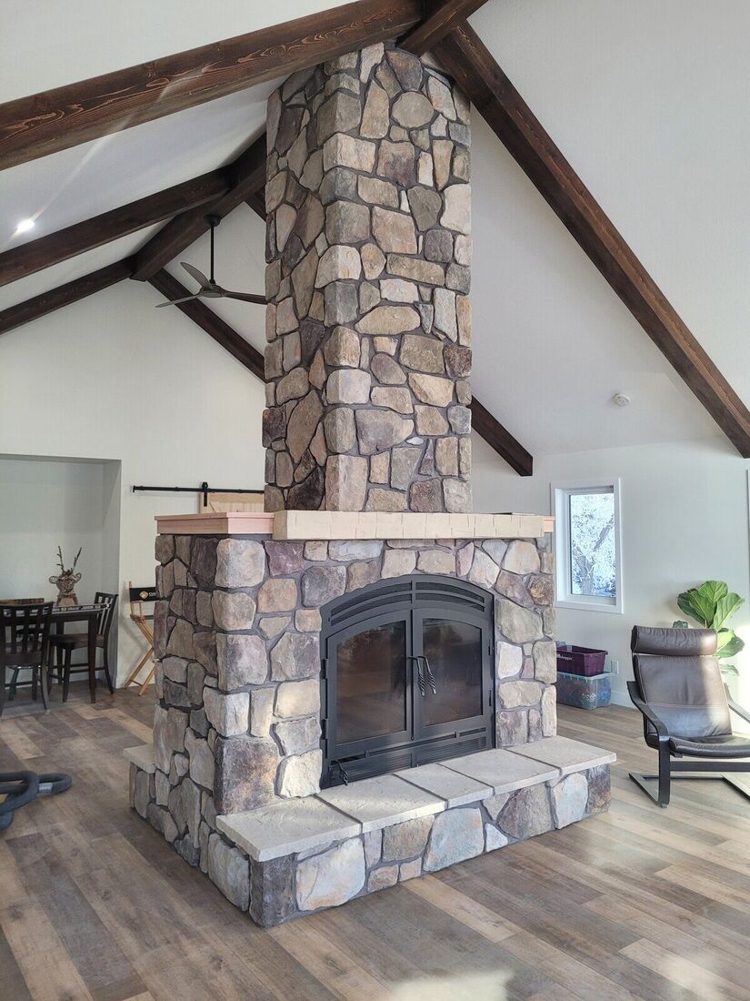 The same fireplace finished in natural fieldstone