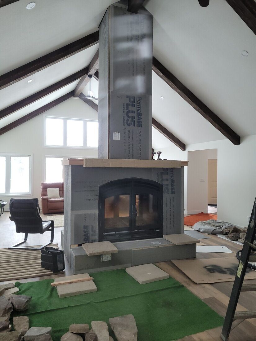Fireplace and chimney wrapped in cement board before stone was applied