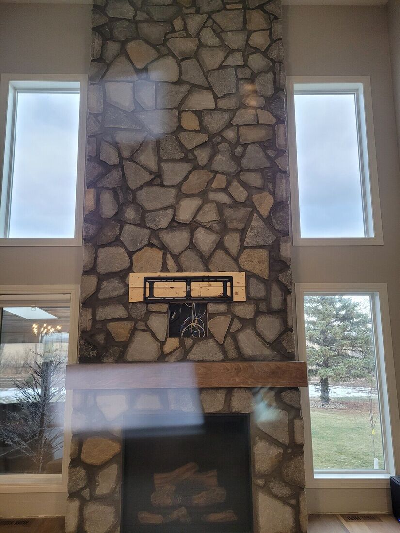 Two-storey fireplace wall finished in stone