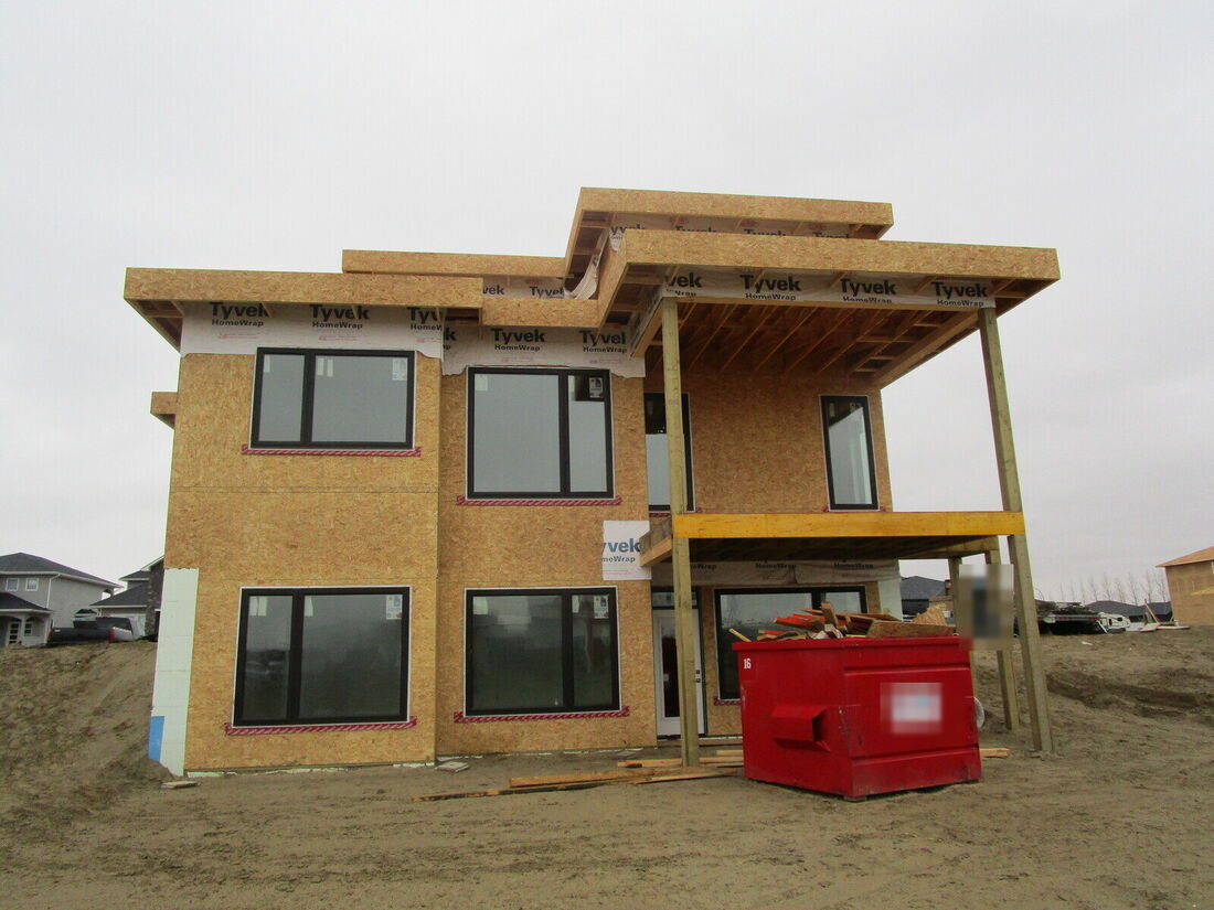Back of a new modern house wrapped in sheathing and house wrap
