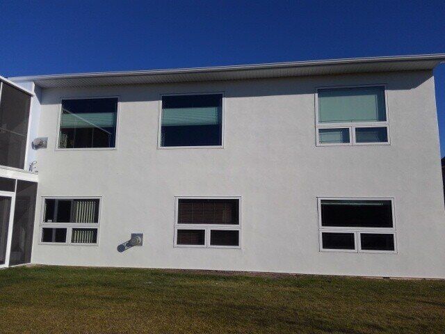 The same house with a fresh white stucco finish