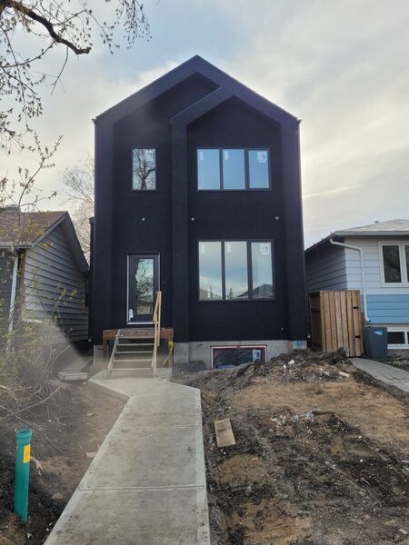 Narrow modern house in dark stucco
