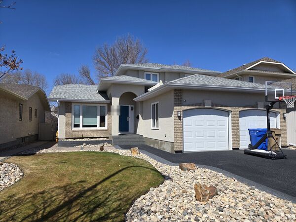 Stucco and brick house with a two-car garage