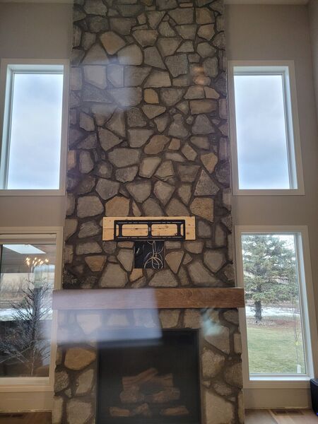 Two-storey fireplace wall finished in stone