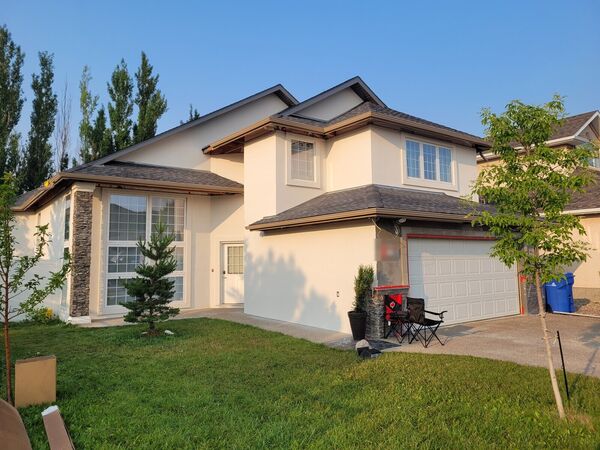 The same house with a new cream stucco finish