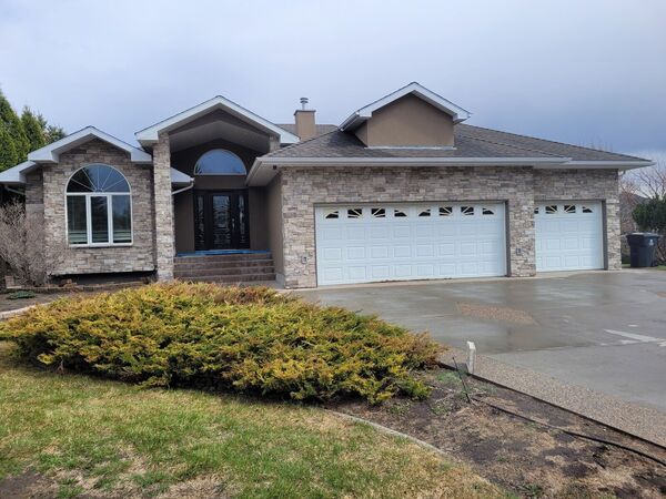 The bungalow front finished in stone and stucco