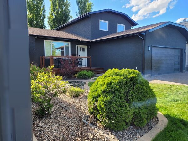 The same house with a dark grey stucco finish