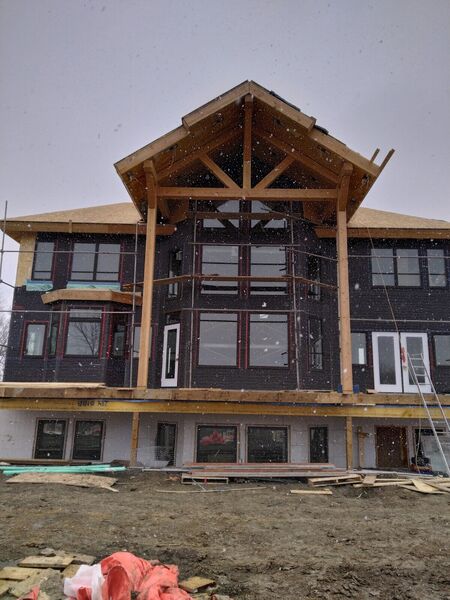 Timber-frame house wrapped and framed